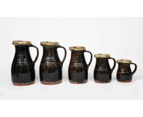 ‡ Richard Batterham (1936-2021)five graduated stoneware jugs, glazed black iron, the top rims ash,painted cobalt mark to tall