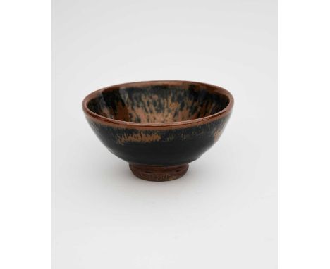 Shoji Hamada (1894-1978)a stoneware footed tea bowl, covered in a streaked iron over tenmoku glaze to the foot, with iron top