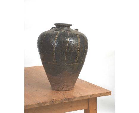 A large south-east Asian shouldered vase with collar rim, shouldered form with three applied loop handles, glaze from the nec