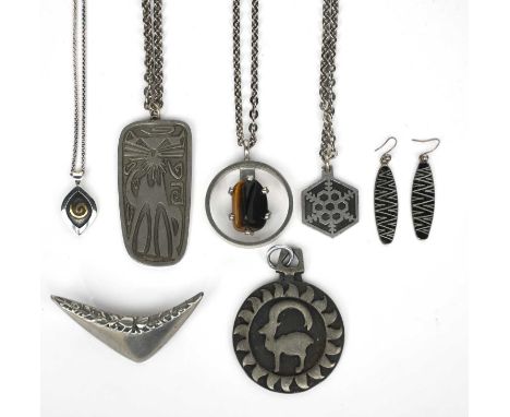 A Jorgen Jensen pewter and tiger's eye pendant necklace, on link chain, two other Jorgen Jensen pewter pendant necklaces, a p
