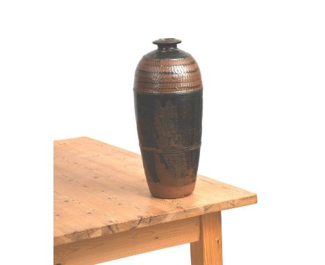 Richard Batterham (1936-2021)a tall two-piece stoneware bottle with chatter bands, covered with a tenmoku glaze to the foot,u