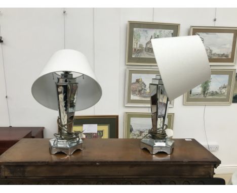 A pair of mirror-covered lamp bases