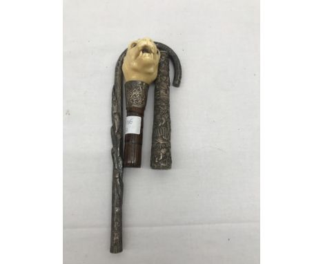 Three 19th century walking stick and parasol handles to inc Oriental, silver and carved ivory bulldog