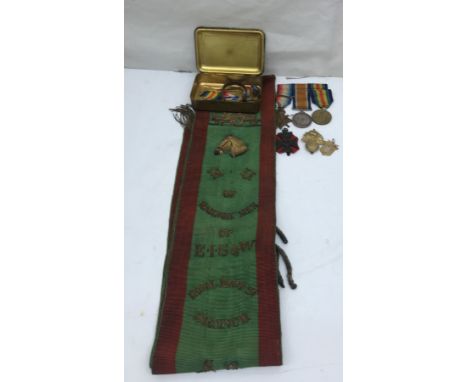 A Princess Mary tin; together with a WWI Trio to 9200 Pte J Edwards, 2 Welsh Regmt; together with cap badges and a sash to th