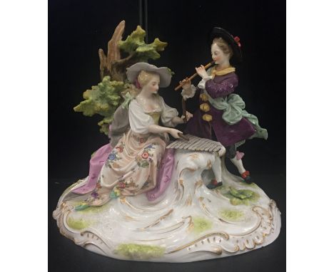 A large German figure of a couple playing musical instruments