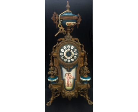 A Victorian clock with porcelain front, ormolu mounts and finial