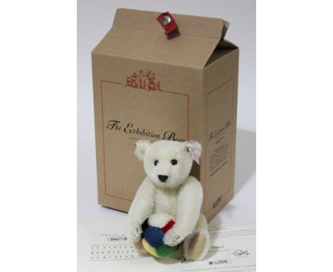 A Steiff The Exhibition Bear, limited edition no667/1500, white mohair teddy bear holding ball complete with ear tag, box and