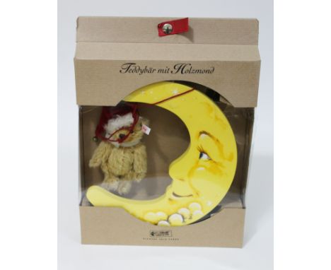 A Steiff teddy bear and wooden moon. 