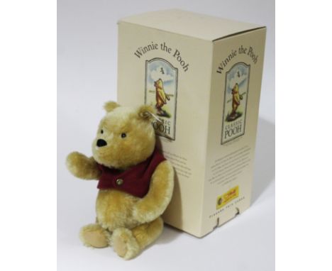 A Steiff Winnie the Pooh bear, limited edition no9391/10000, blond mohair teddy bear with waist coast, ear tag and box. 