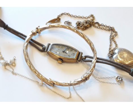 A mixed lot comprising a hallmarked 9ct gold bangle weight 4.4g (broken), a 9ct gold Art Deco style wristwatch, a gold front 