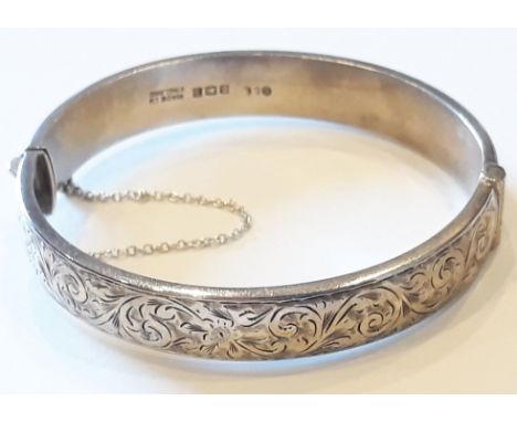 A hallmarked silver bangle, diam. 6cm.Condition: clasp in good working order, minor wear and tarnishing to outer surface, hal