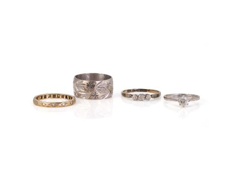 A group of four rings, comprising a 9ct white gold star motif texture band, London 1974, inscribed on reverse 'Chi 2.10.48 - 