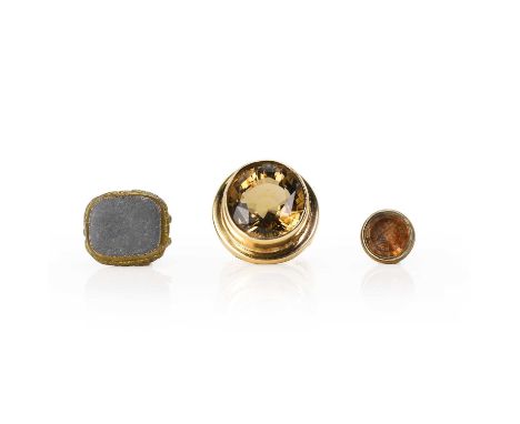 A 9ct gold smoky quartz ring and two base metal fobs, a large round cut smoky quartz, bezel set to a plain raised mount into 