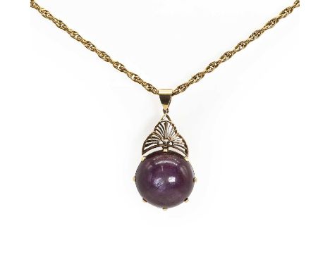 A large purplish red star ruby pendant and chain, with a round cabochon star ruby, 21mm diameter, eight claw set to a collet 