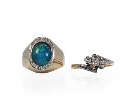 A gold diamond crossover ring and an opal triplet ring, a gold diamond three stone crossover ring, with a line of eight cut d