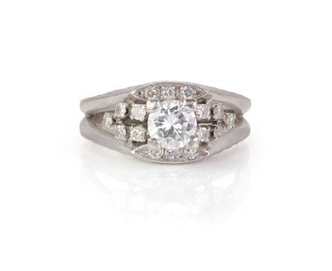 A white gold diamond ring,  with a principal round brilliant cut diamonds, claw set, decorated further with smaller round bri
