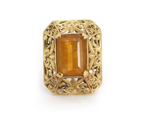 A gold citrine set pierced scroll design ring,  a rectangular mixed cut citrine claw set to a raised pierced gallery, to orna