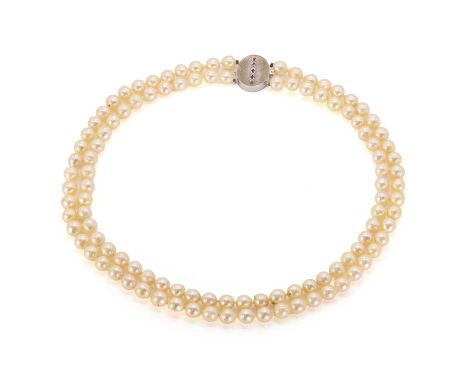 A two-row uniform pearl necklace with ruby and diamond set textured clasp, the necklace with pearls 7mm in size, untested, st