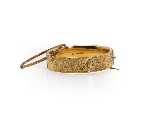 Two 9ct gold bangles, comprising a 9ct gold hollow hinged oval bangle, with a hand engraved foliate panel and concealed box c