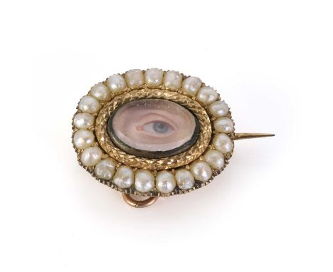 An antique lover's eye miniature brooch, the hand-painted eye miniature beneath a glazed cover, to an applied carved surround