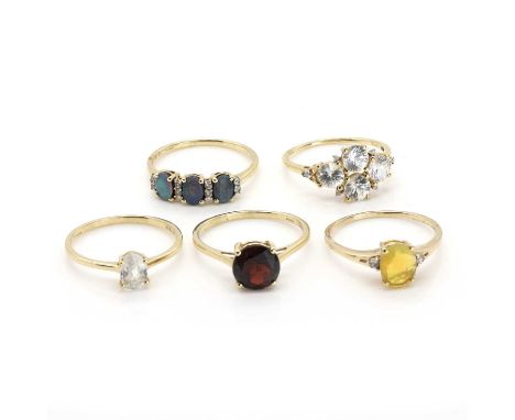 A group of five 9ct gold gem set rings, comprising a 9ct gold Ethiopian opal ring, a 9ct gold red stone ring, a 9ct gold opal