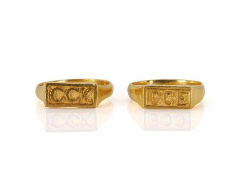 Two high carat gold initial rings, each of the same design, the rectangular top on each with the initial CCK and GCE, both be