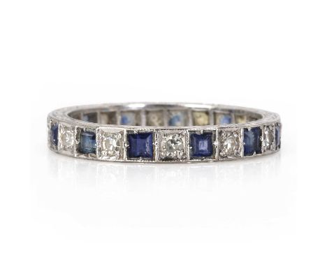 A sapphire and diamond full eternity ring, c.1950,  set with eight cut diamonds and calibre cut sapphires in millegrain box c