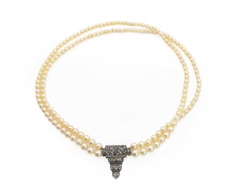 A graduated cultured pearl necklace with an Art Deco style paste clasp, with two rows of graduated cultured pearls, untested,