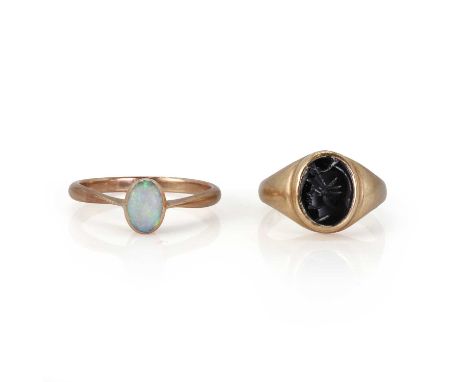 A 9ct gold onyx ring and an opal ring, a 9ct gold onyx signet ring,the carved onyx tablet depicting the head of a soldier, in