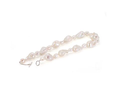 A Keshi pearl necklace, with large non-nucleated pearls alternating in size, approximately 13mm to 34mm in size, strung knott