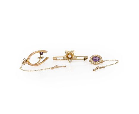 A trio of Victorian and later gold brooches, comprising:a gold amethyst and split pearl brooch,with an oval cut amethyst, sur