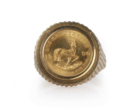 A gold 1/10 oz Krugerrand coin ring, a 1/10 oz Krugerrand coin ring, dated 1980, spectacle set to a 9ct gold mount, 20mm diam