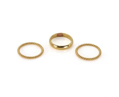 Three small gold rings, one plain band, and two rope twist bands, the plain band stamped 22k, both rope twist bands unmarked,
