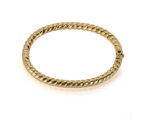 A twist rope hollow bangle, a gold hinged bangle, stamped 750, 70mm in diameter, tested as approximately 18ct gold, 19.38gCon