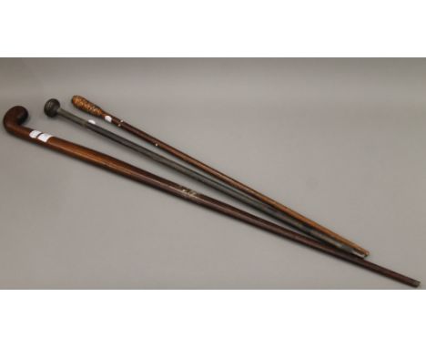 A Victorian mahogany Sunday stick and two other walking sticks. The former 90.5 cm long.