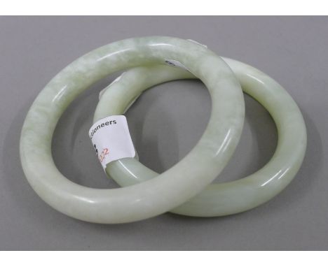 A pair of Chinese light green jade bangles. 8.5 cm exterior diameter, interior measurement 6.5 cm. 