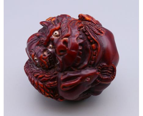 A netsuke decorated with various animals. 5 cm diameter.
