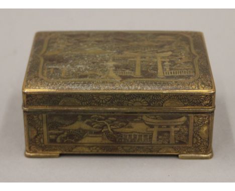 A Japanese brass box, the underside inscribed K 24 Gold Inlaid. 10 cm wide.