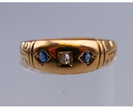 An 18 ct gold diamond and sapphire gypsy set ring. Ring size N/O. 2.3 grammes total weight.