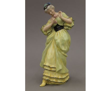 A Royal Doulton figurine, Lady with Rose - E W Light, HN 68 No 12. 25 cm high.
