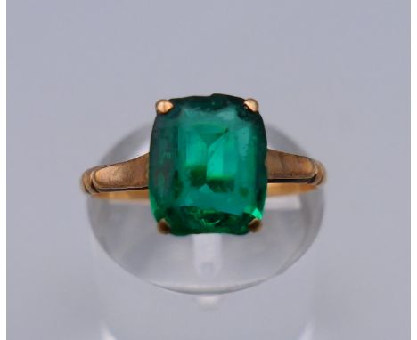 A 9 ct single green stone ring. Ring size L. 2 grammes total weight.