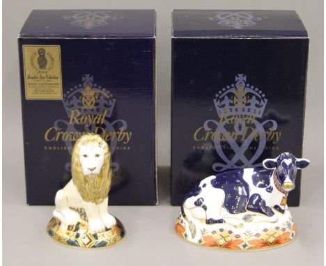 Two boxed Royal Crown Derby paperweights, Friesian Cow Buttercup and Heraldic Lion.