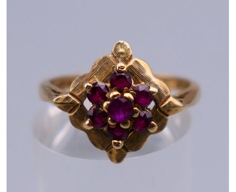 A 9 ct gold ring with flowerhead setting. Ring size N/O. 2.6 grammes total weight.