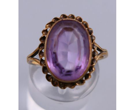 A 9 ct gold and oval amethyst ring. Ring size O. 3.3 grammes total weight.