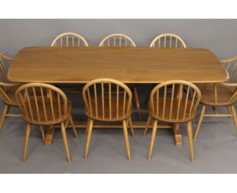 A blonde Ercol dining suite, comprising table, set of eight chairs and a sideboard. The table 193 cm long x 84.5 cm wide. The