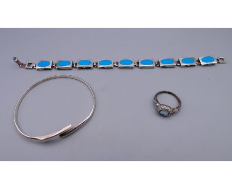 A silver bangle, a silver bracelet and a silver blue stone ring.  Bracelet 20 cm long. 