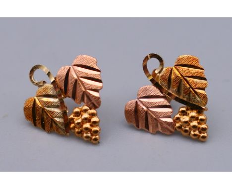A pair of 10 K gold grape leaf form earrings.  1.5 cm high. 