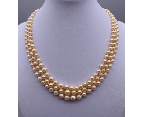 A three strand pearl necklace with a 9 ct gold clasp.  Approximately 40 cm long. 