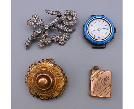 A mourning brooch, a book form pendant, a silver and enamel cased ladies watch and a flower spray brooch.  Mourning brooch 3.