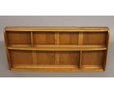 A blonde Ercol wall shelf. 